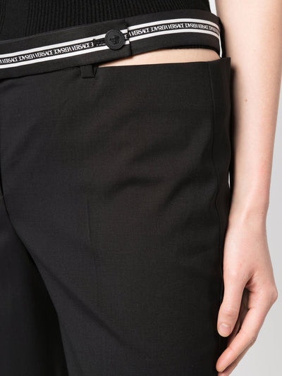 1B000 VERSACE cut-out logo-waistband trousers