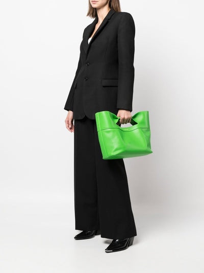 Woman holding a Acid Green Alexander Mcqueen The Bow Small Bag